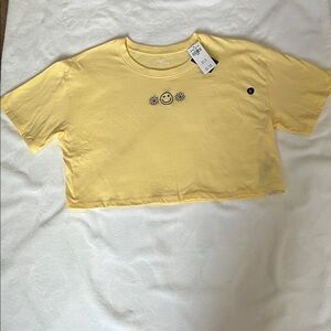 Hollister Yellow Crop Tee with Smiley and Flower Design.